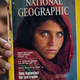 In an Oct. 26, 2016 photo, the owner of a book shop in Islamabad, Pakistan, shows a copy of a National Geographic magazine with a photo of Sharbat Gulla, an Afghan refugee, on the cover.